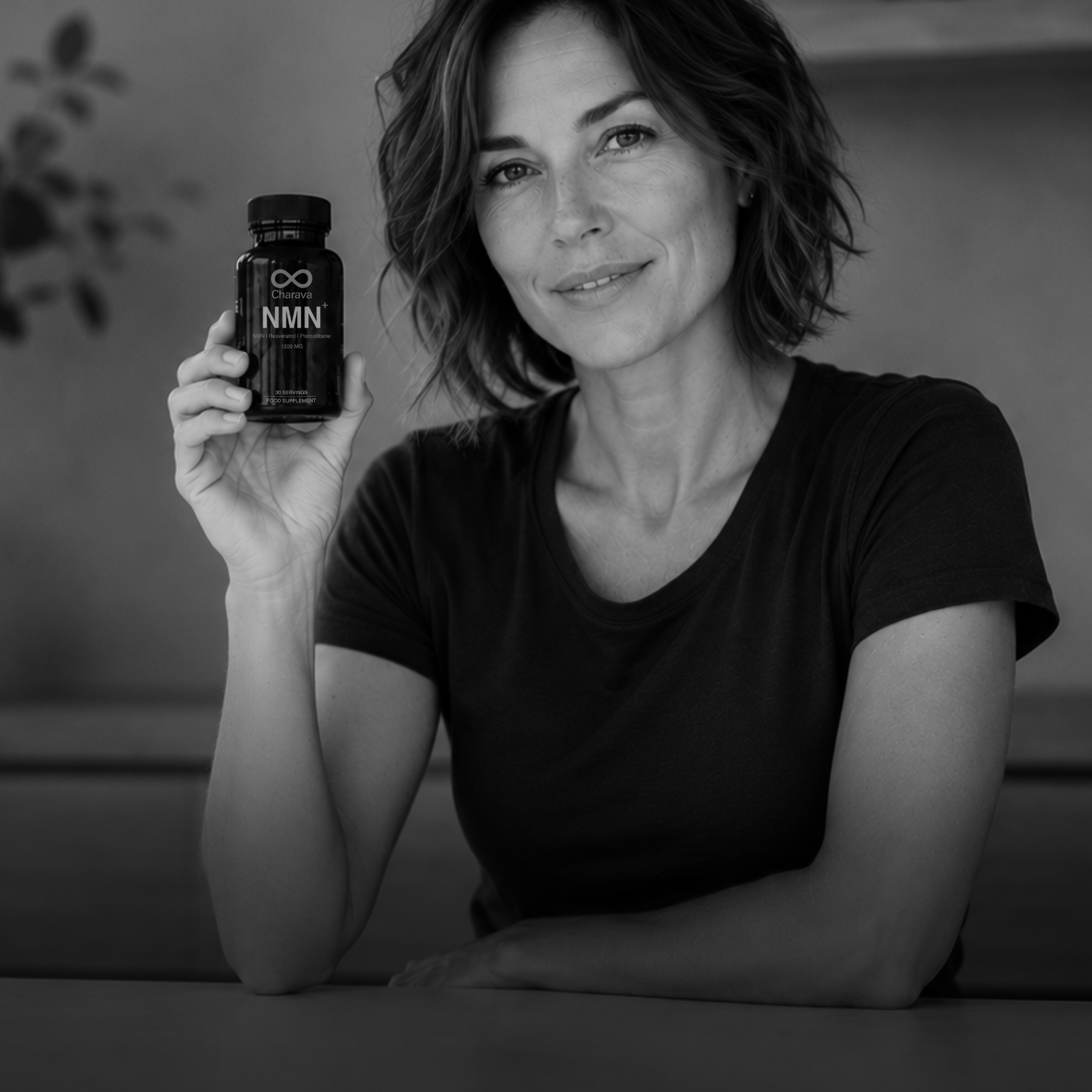 Woman holding a bottle of NMN supplements in a black and white photo